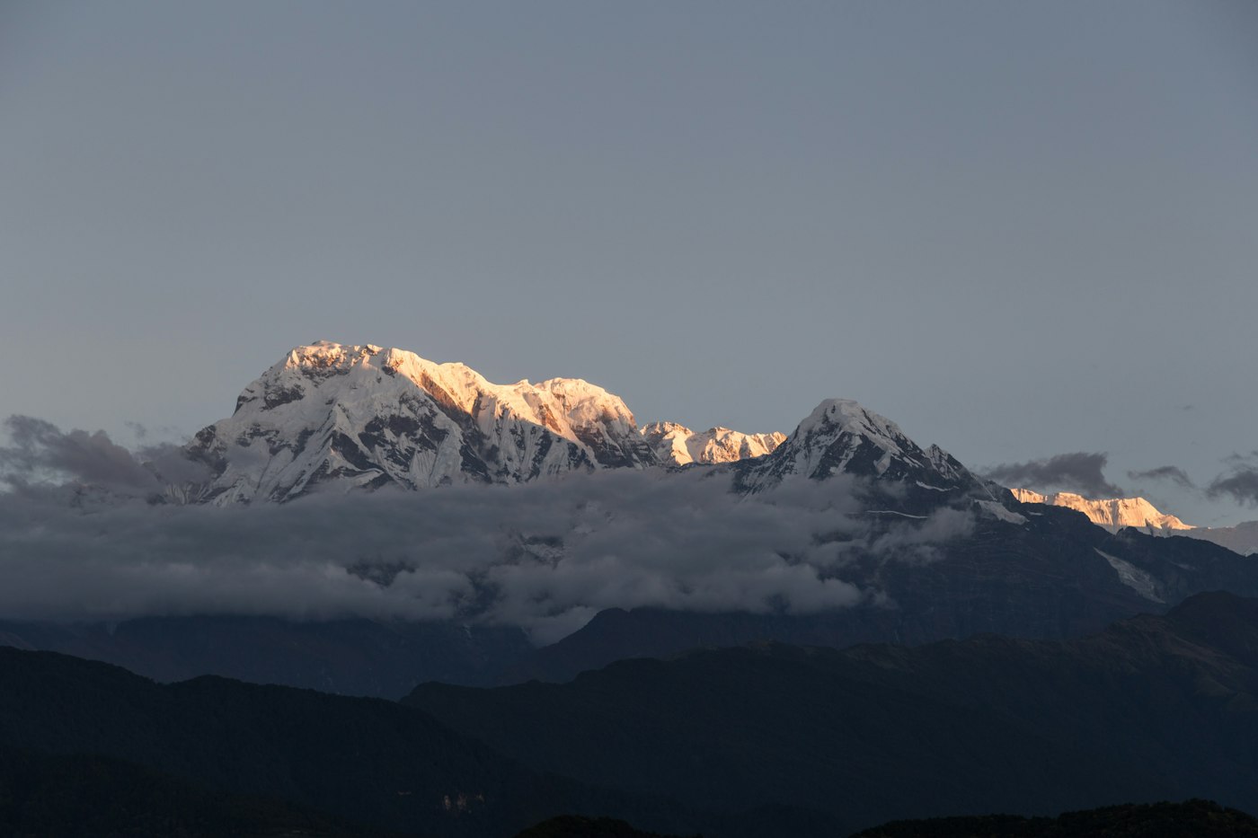 The Annapurna range in Nepal lit by the first light of dawn above the clouds